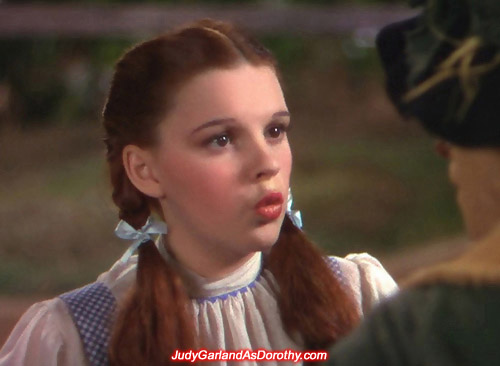 Judy Garland as Dorothy blows the Scarecrow a kiss