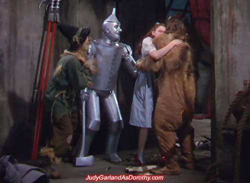 Judy Garland as Dorothy gives the Cowardly Lion a bear hug