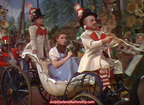 Judy Garland as Dorothy is treated like a princess on a horse-drawn carriage