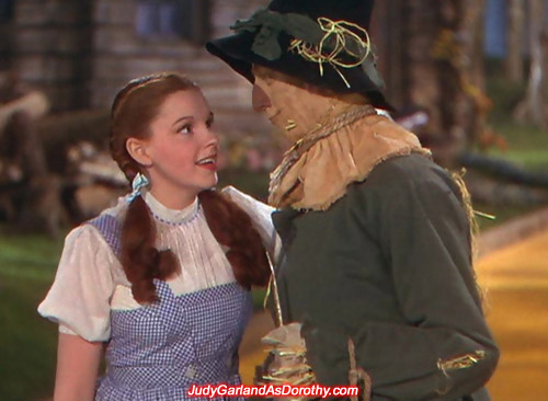 Judy Garland as Dorothy sees eye to eye with the Scarecrow