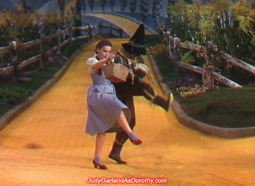 Judy Garland as Dorothy shows off her dancing skills with the Scarecrow