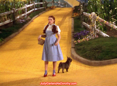 Teen powerhouse Judy Garland as Dorothy looking around on the Yellow Brick Road