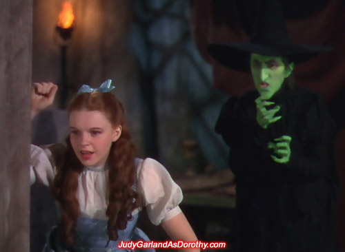 The Wicked Witch of the West keeps a close eye on Judy Garland as Dorothy